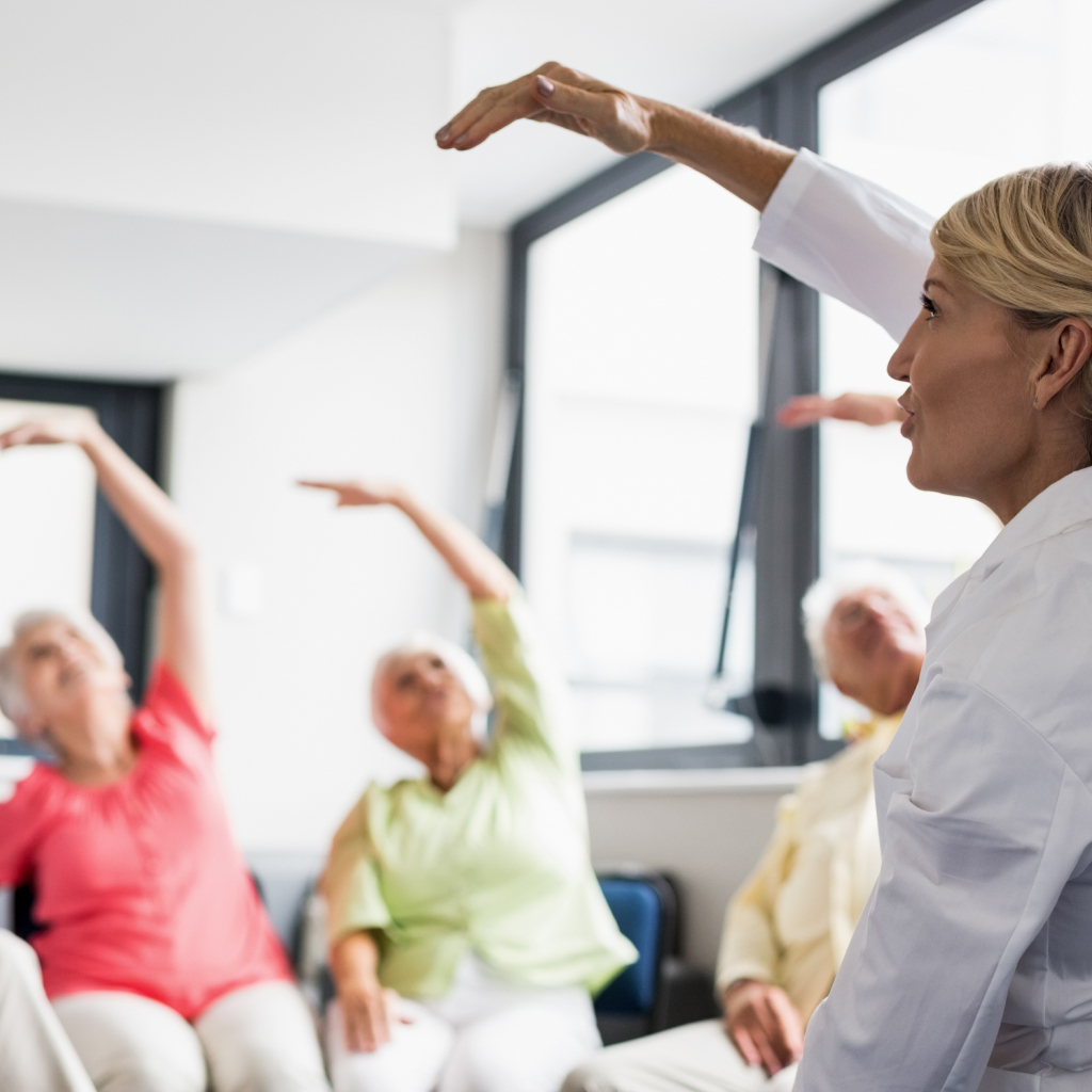 Physical Therapist Teaching Class to Older Patients